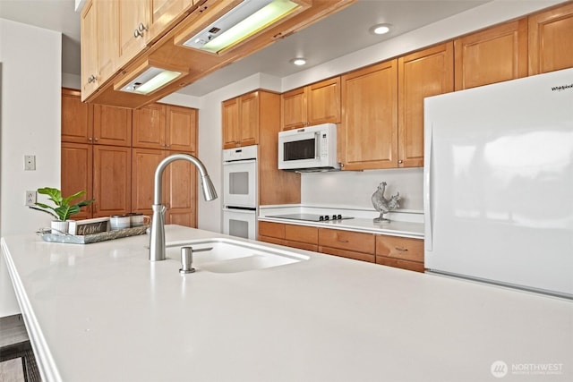 742 I St SW, Quincy, WA 98848 - kitchen featuring white appliances, light countertops, a breakfast bar area, recessed lighting, and a sink