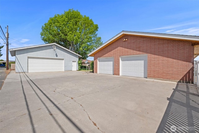 742 I St SW, Quincy, WA 98848 - view of property exterior featuring a garage, an outbuilding, and brick siding