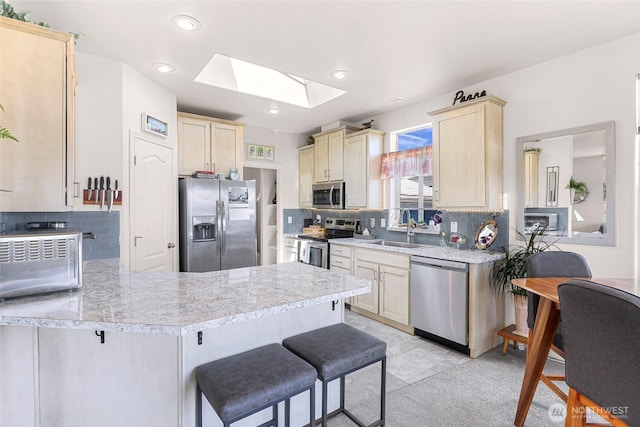8412 Richard Way, Blaine, WA 98230 - kitchen with stainless steel appliances, a sink, a skylight, light countertops, and a peninsula