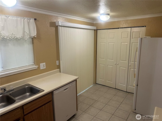 14917 32nd Pl S Unit 42, Seatac, WA 98168 - kitchen with white appliances, crown molding, a sink, light tile patterned floors, and light countertops