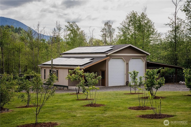 5363 Reese Hill Rd, Sumas, WA 98295 - view of front of home featuring a mountain view, solar panels, a front yard, and a detached garage