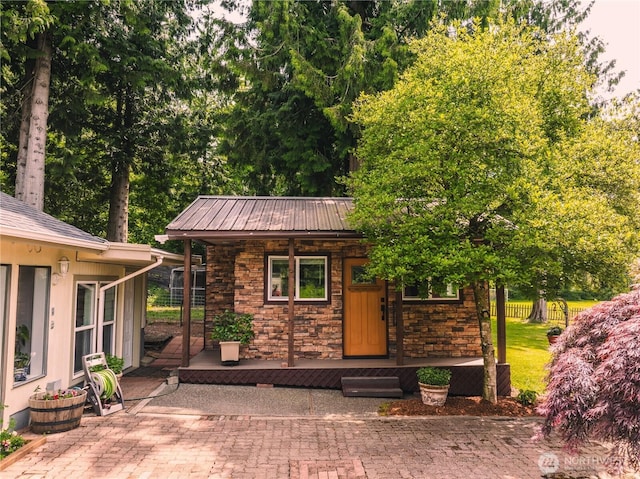 5363 Reese Hill Rd, Sumas, WA 98295 - view of front of home featuring a porch, stone siding, and metal roof