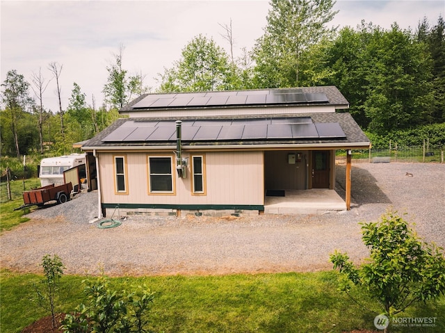 5363 Reese Hill Rd, Sumas, WA 98295 - rear view of property with solar panels, a porch, and gravel driveway