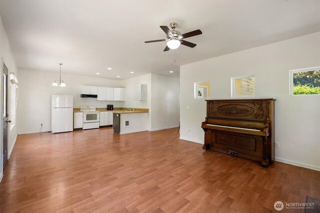 12 Fairgrounds Rd, Skamokawa, WA 98647 - living area with a ceiling fan, baseboards, wood finished floors, recessed lighting, and a chandelier