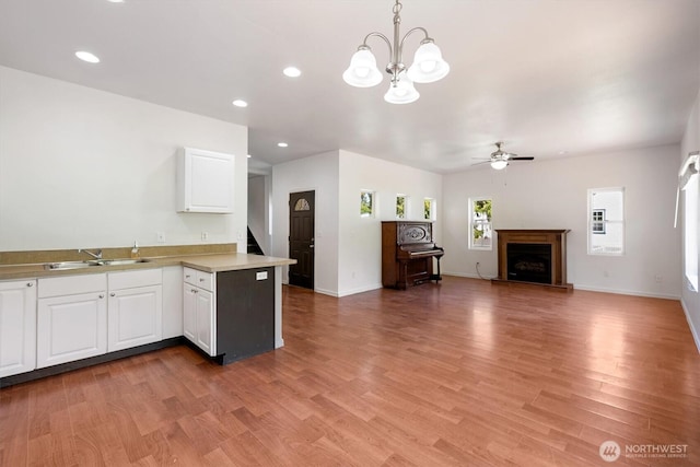 12 Fairgrounds Rd, Skamokawa, WA 98647 - kitchen with a sink, ceiling fan, a chandelier, light countertops, and white cabinetry