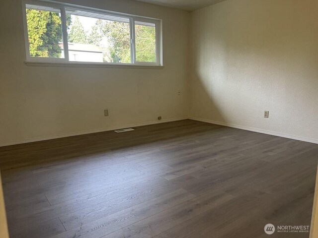 27 SW 102nd St, Seattle, WA 98146 - spare room with dark wood-style floors and baseboards