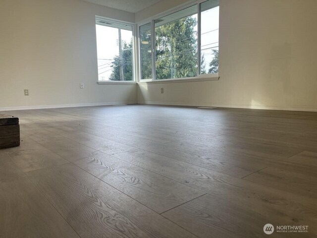 27 SW 102nd St, Seattle, WA 98146 - unfurnished room featuring plenty of natural light, hardwood / wood-style floors, and baseboards