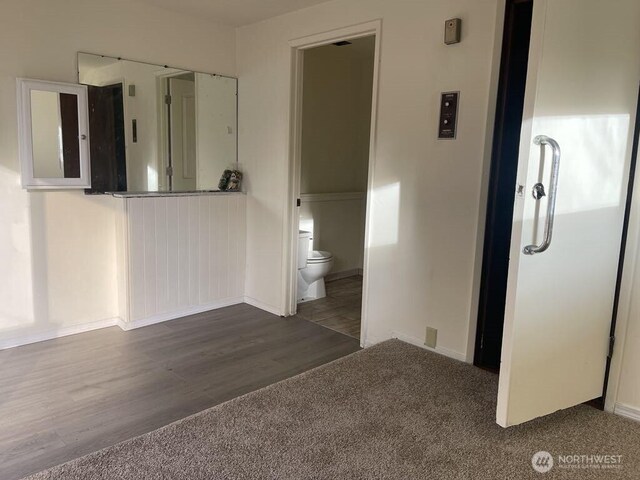 27 SW 102nd St, Seattle, WA 98146 - unfurnished bedroom featuring baseboards, wood finished floors, connected bathroom, and carpet