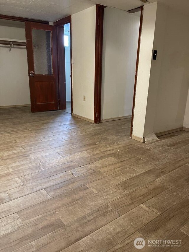 27 SW 102nd St, Seattle, WA 98146 - basement featuring wood-type flooring and baseboards