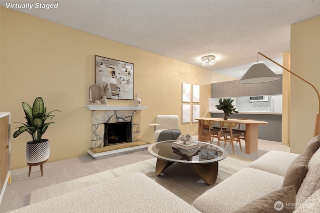 5814 200th St SW Unit D, Lynnwood, WA 98036 - living room with a stone fireplace, a textured ceiling, and carpet floors