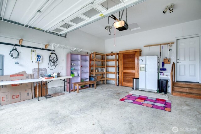 566 Duck Lake Dr SE, Ocean Shores, WA 98569 - garage with white refrigerator with ice dispenser and a garage door opener