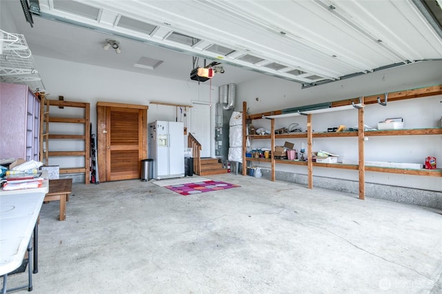 566 Duck Lake Dr SE, Ocean Shores, WA 98569 - garage featuring a garage door opener and white refrigerator with ice dispenser