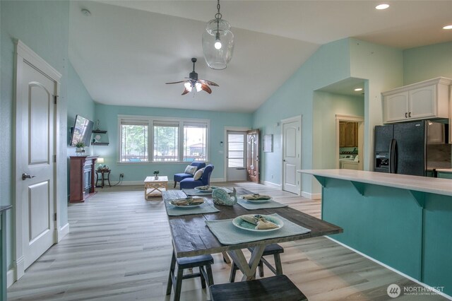 566 Duck Lake Dr SE, Ocean Shores, WA 98569 - dining area with lofted ceiling, light wood finished floors, baseboards, ceiling fan, and recessed lighting
