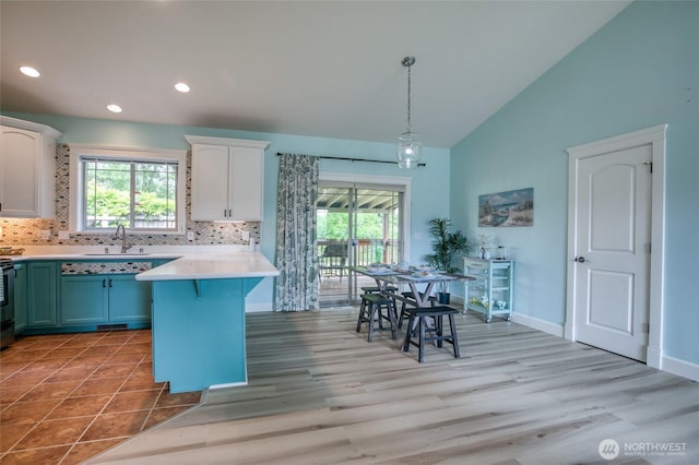 566 Duck Lake Dr SE, Ocean Shores, WA 98569 - kitchen featuring a sink, white cabinetry, light countertops, backsplash, and recessed lighting