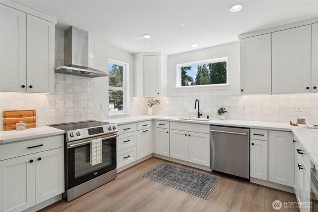 20313B 14th Ave NE, Shoreline, WA 98155 - kitchen featuring stainless steel appliances, wall chimney range hood, a sink, light countertops, and recessed lighting