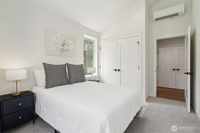 20313B 14th Ave NE, Shoreline, WA 98155 - bedroom with a wall mounted air conditioner, a closet, vaulted ceiling, light colored carpet, and baseboards