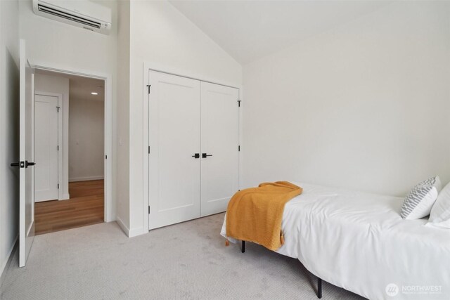 20313B 14th Ave NE, Shoreline, WA 98155 - bedroom with an AC wall unit, lofted ceiling, a closet, carpet, and baseboards