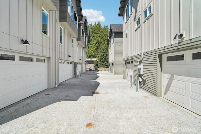 20313B 14th Ave NE, Shoreline, WA 98155 - view of property exterior with board and batten siding, driveway, and a garage