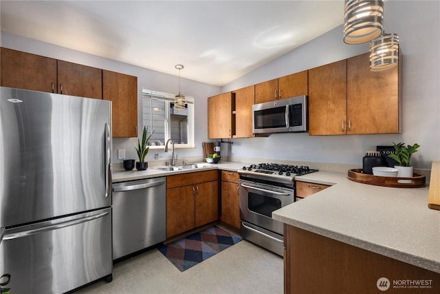 3907 SW 102nd St, Seattle, WA 98146 - kitchen featuring appliances with stainless steel finishes, a sink, brown cabinetry, light countertops, and hanging light fixtures