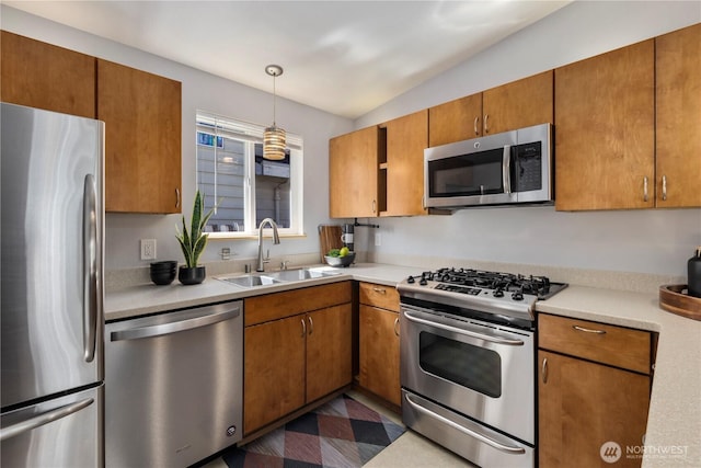 3907 SW 102nd St, Seattle, WA 98146 - kitchen with appliances with stainless steel finishes, a sink, light countertops, brown cabinetry, and lofted ceiling