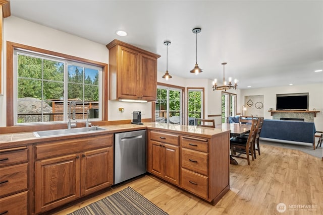 12606 Icicle Ln, Leavenworth, WA 98826 - kitchen featuring dishwasher, a sink, light wood-type flooring, light countertops, and brown cabinets