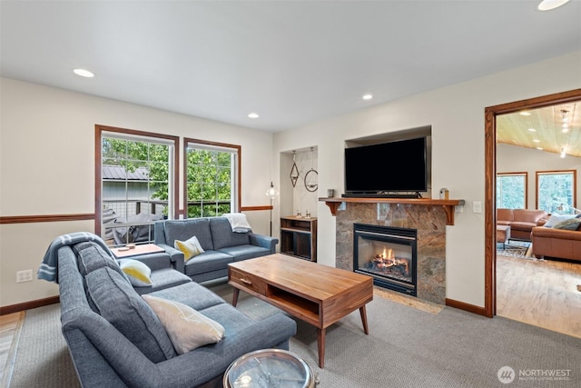 12606 Icicle Ln, Leavenworth, WA 98826 - living area with healthy amount of natural light, recessed lighting, a premium fireplace, baseboards, and wood finished floors