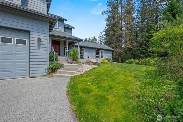 12606 Icicle Ln, Leavenworth, WA 98826 - entrance to property with a garage, a lawn, covered porch, and roof with shingles