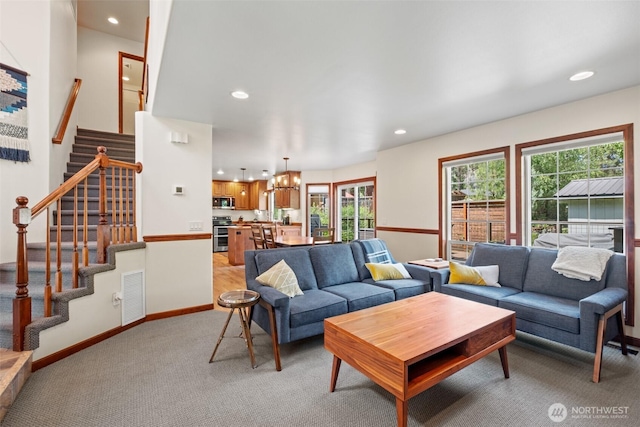 12606 Icicle Ln, Leavenworth, WA 98826 - living area featuring light colored carpet, a chandelier, healthy amount of natural light, recessed lighting, and stairway