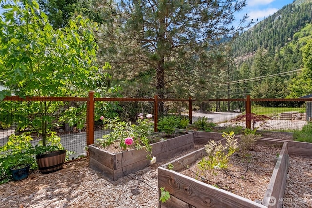 12606 Icicle Ln, Leavenworth, WA 98826 - view of yard featuring a garden, a wooded view, and a mountain view