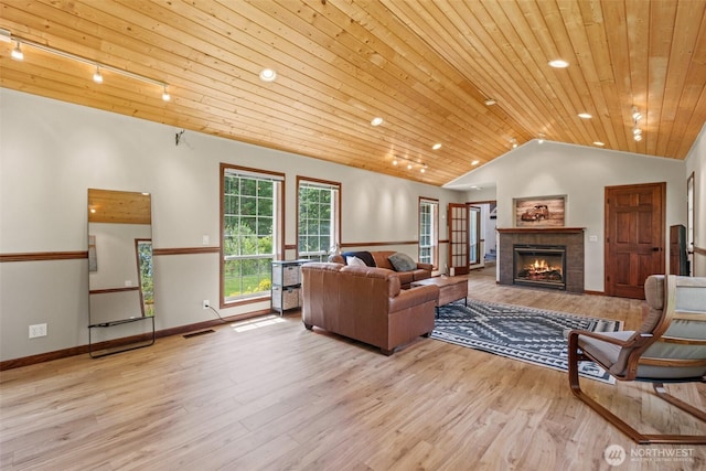 12606 Icicle Ln, Leavenworth, WA 98826 - living area with vaulted ceiling, wooden ceiling, wood finished floors, a fireplace, and track lighting