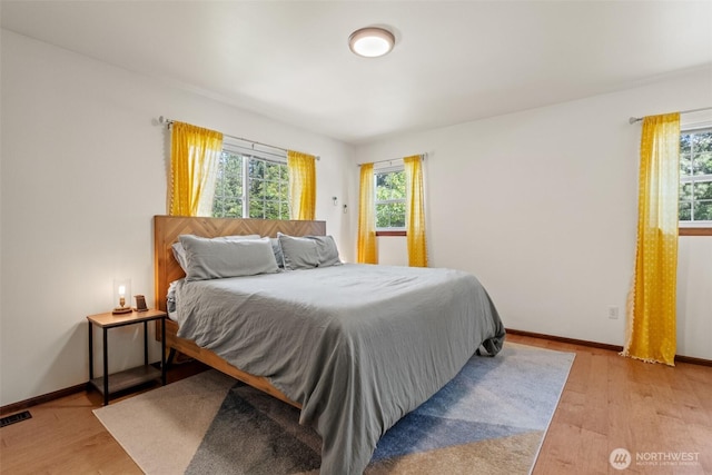 12606 Icicle Ln, Leavenworth, WA 98826 - bedroom with multiple windows, light wood-style floors, and baseboards