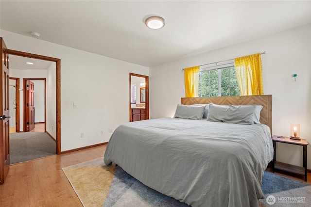 12606 Icicle Ln, Leavenworth, WA 98826 - bedroom with light wood finished floors, ensuite bathroom, and baseboards