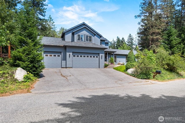 12606 Icicle Ln, Leavenworth, WA 98826 - traditional-style house featuring asphalt driveway, a garage, and roof with shingles