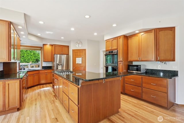 18913 SE 174th Way, Renton, WA 98058 - kitchen featuring stainless steel appliances, a kitchen island, light wood finished floors, dark stone counters, and recessed lighting