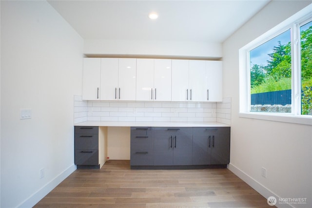 12215 Des Moines Memorial Dr S Unit A, Burien, WA 98168 - kitchen with gray cabinetry, backsplash, light countertops, light wood-type flooring, and recessed lighting