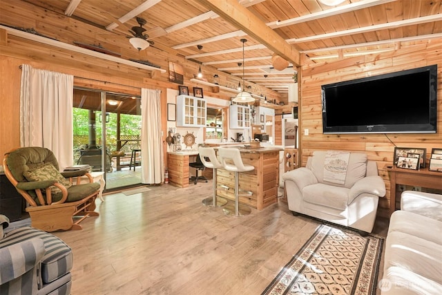 1190 Exit Rd, Maple Falls, WA 98266 - living room with wooden walls, a wood ceiling with exposed beams, light wood-style floors, and a ceiling fan