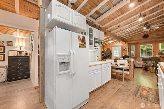 1190 Exit Rd, Maple Falls, WA 98266 - kitchen with white refrigerator with ice dispenser, open floor plan, light wood-type flooring, white cabinetry, and wood ceiling