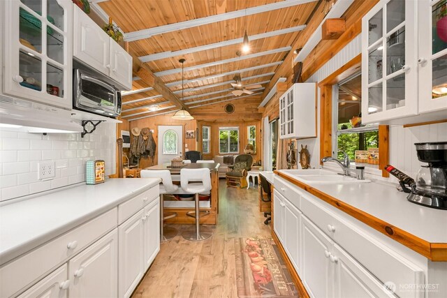 1190 Exit Rd, Maple Falls, WA 98266 - kitchen with wooden ceiling, light wood-type flooring, white cabinetry, light countertops, and ceiling fan