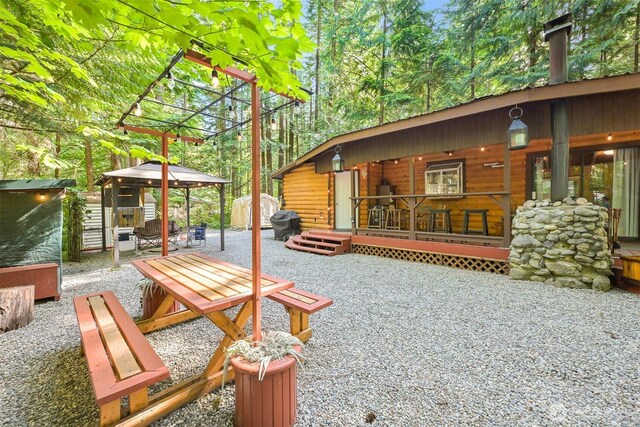 1190 Exit Rd, Maple Falls, WA 98266 - view of patio / terrace with a gazebo, a shed, and a wooden deck