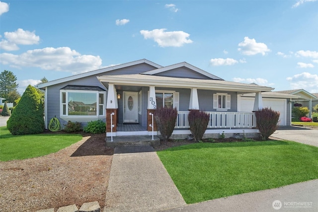 302 Oak St SW, Orting, WA 98360 - view of front facade with driveway, covered porch, a front yard, and an attached garage