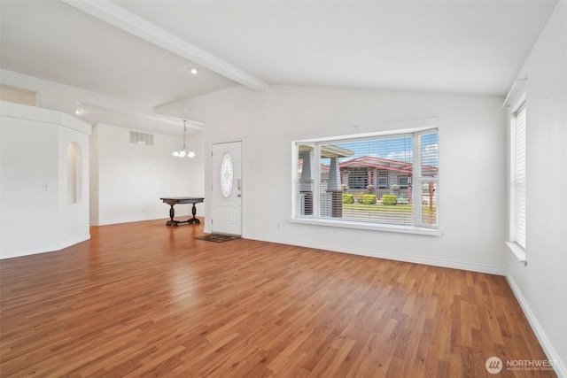 302 Oak St SW, Orting, WA 98360 - unfurnished living room with light wood-type flooring, a chandelier, plenty of natural light, and baseboards