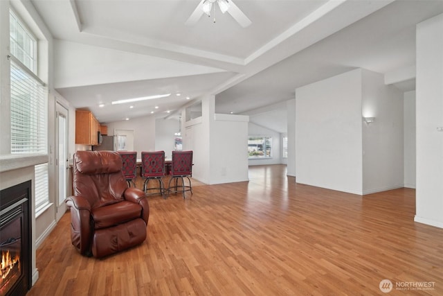 302 Oak St SW, Orting, WA 98360 - living room with a glass covered fireplace, light wood-style floors, a ceiling fan, recessed lighting, and lofted ceiling