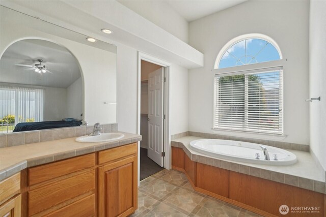 302 Oak St SW, Orting, WA 98360 - ensuite bathroom featuring plenty of natural light, a garden tub, vanity, and ceiling fan