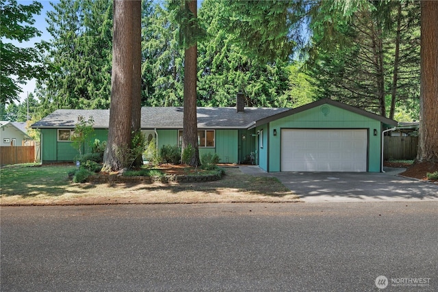 5505 Windemere Dr SE, Olympia, WA 98501 - ranch-style home with a garage, concrete driveway, a chimney, and roof with shingles