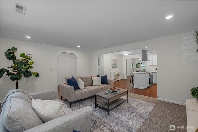 5505 Windemere Dr SE, Olympia, WA 98501 - carpeted living area with arched walkways, recessed lighting, and baseboards