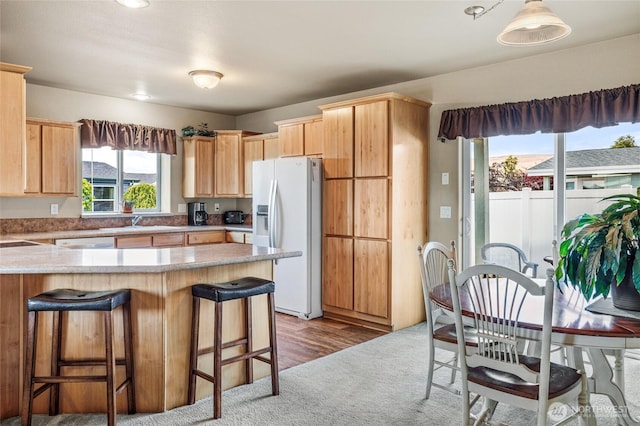 200 Bridle Way Unit 249, Yakima, WA 98901 - kitchen with white refrigerator with ice dispenser, a peninsula, a kitchen bar, and a sink