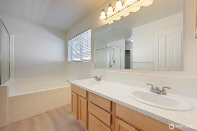 3147 6th Ave NW, Olympia, WA 98502 - full bath with a garden tub, double vanity, a stall shower, wood finished floors, and decorative backsplash