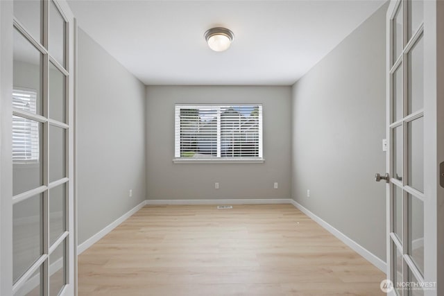 3147 6th Ave NW, Olympia, WA 98502 - unfurnished room featuring french doors, light wood-type flooring, and baseboards