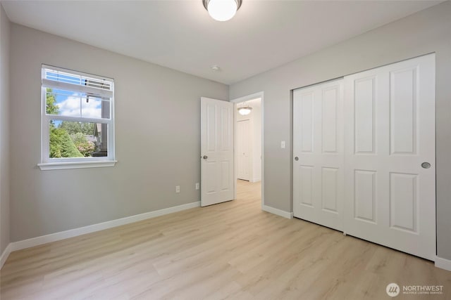 3147 6th Ave NW, Olympia, WA 98502 - unfurnished bedroom featuring light wood-style floors, baseboards, and a closet