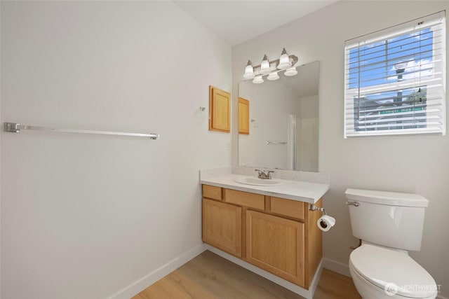 3147 6th Ave NW, Olympia, WA 98502 - full bath with vanity, toilet, wood finished floors, and baseboards